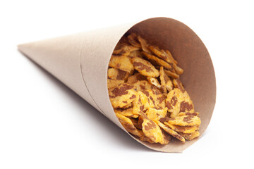 Close-up of Spicy Chana Jor Garam In handmade ( handcraft ) brown paper cone bag, made with air-fried Bengal Chickpea. Pile of Indian spicy snacks (Namkeen),