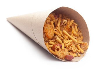 Close-Up of Spicy Chatpata Mixture In handmade ( handcraft ) brown paper cone bag made with peanuts, corn flakes. Indian spicy snacks (Namkeen)