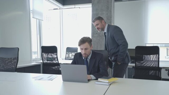 Nervous male boss shouting at colleague for work mistake, poor business ethics