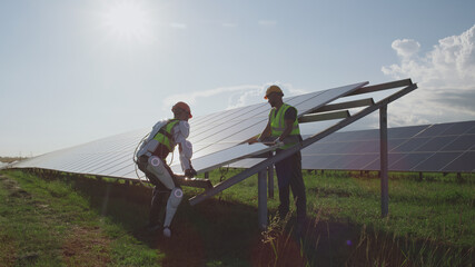 Male engineers installing solar panels together