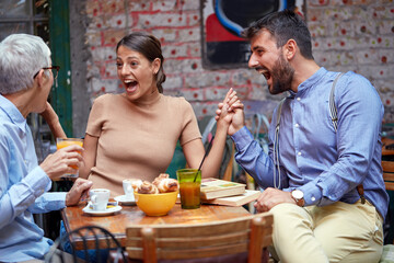 different age and gender people socializing, looking surprised, laughing, holding hands
