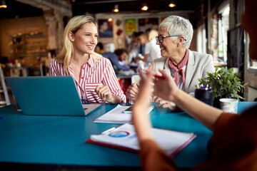 Female colleagues are chatting while working in the office together