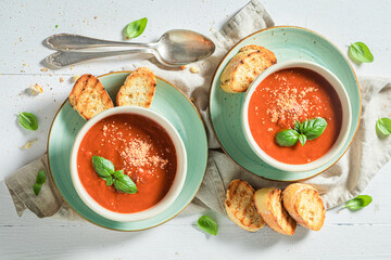 Homemade tomato soup with toasts and basil. Soup with croutons.