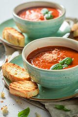 Delicious tomato soup with toasts and basil. Soup with croutons.
