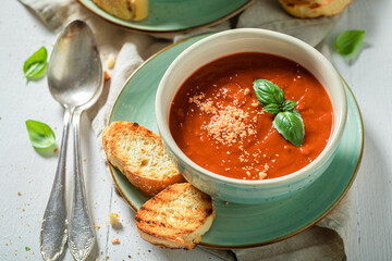 Hot tomato soup made of tasty tomatoes. Soup with parmesan
