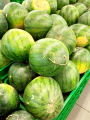 a lot of green watermelons in a green basket photo