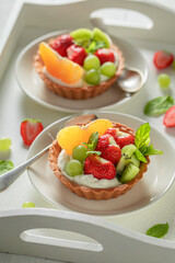 Homemade mini tart with various fruits. Simple summer dessert.