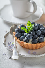 Simple summer dessert. Mini tart with blueberries and cream.