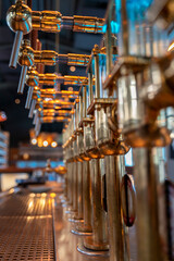 close-up of golden beer pump inside a brewery