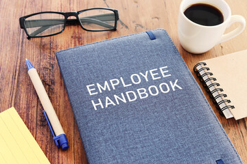 Concept image of employee handbook over wooden office table. top view - obrazy, fototapety, plakaty