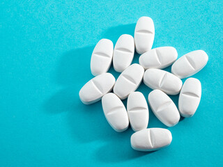 lot of medicine pills on blue background. 