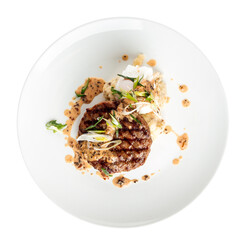 Isolated plate of gourmet grilled beef cutlet with sauce