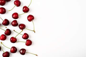 Obraz na płótnie Canvas Frame of large ripe cherry berries on a white background