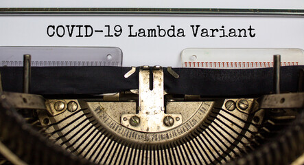 Covid-19 lambda virus variant symbol. Words 'Covid-19 lambda variant' typed on retro typewriter. Medical and COVID-19 new lambda variant concept.