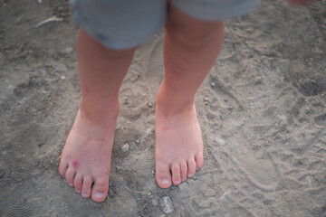 Fototapeta na wymiar Baby feet playing in sand