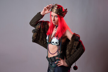 carnival queen. A young woman with bright pink hair in a Mardi Gras costume,