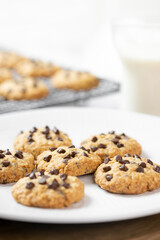 Delicious Whole Wheat Chocolate Chip Cookies set on white cafe table.