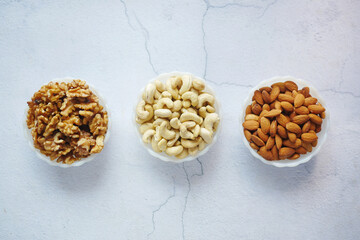 walnut , cashew nut and almond in a container on table 