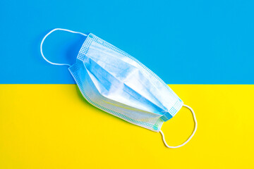 Protective face mask on the flag of Ukraine. COVID-19. Quarantine measures. Closing borders between...
