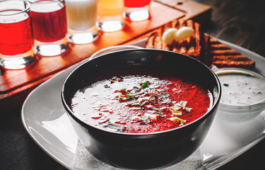 Beetroot soup Traditional Ukrainian or Russian borscht with sour cream in a bowl on wooden table