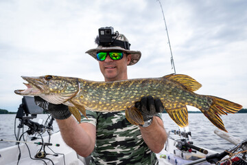 Swedish pike fishing from the boat