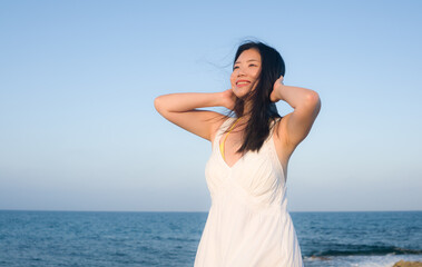 young happy and beautiful Asian woman by the sea - Attractive Korean girl cheerful enjoying relaxed summer holidays at tropical island in travel and lifestyle concept