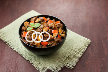 Spicy beef kaya curry beef fry South Indian Kerala India Sri Lanka. side dish Ghee rice, Appam, Parotta, Puttu. traditional Christian Muslim feast dish. Buffalo roast, meat pepper fry raw curry banana