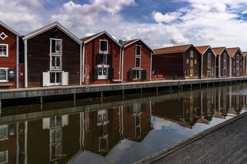 red and brown wooden warehouses along the waterfront in Hudiksvall