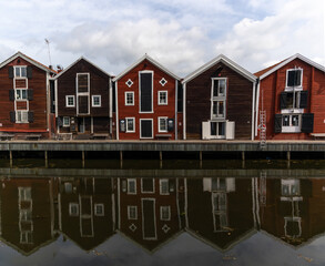 red and brown wooden warehouses along the waterfront in Hudiksvall