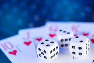 Online gaming platform, casino and gambling business. Cards and dice on laptop keyboard, toned in blue
