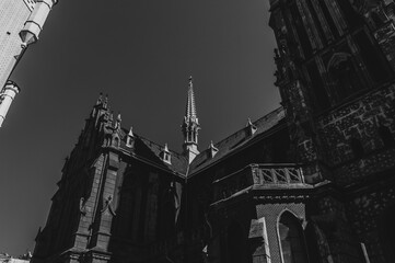 Black and white photo of old catholic church. Cathedral in black and white colours in sunny day. Peak of catholic church roof. Saint Nicholas Cathedral in Kyiv, Ukraine