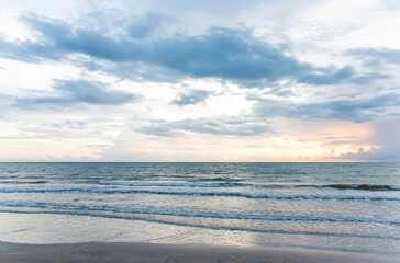 Fototapeta na wymiar The sea at dusk, the sun is falling, the waves are soft.