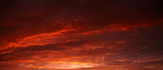 Fototapeta premium Red sunset sky with dramatic clouds