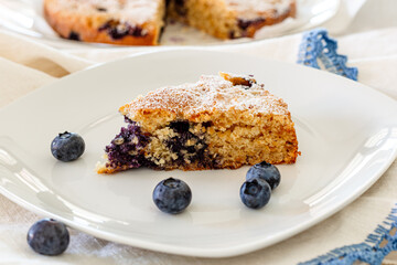 Slice of coconut and blueberry cake. Vegan recipe. No sugar