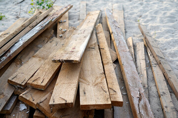 Fototapeta na wymiar Wooden planks on the sand, lumber, board 