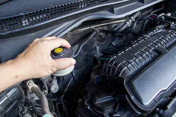 Close up hand a man checking brake fluid maintenance and basic service concept in the car and brake...