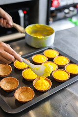 Asian girl cooking egg tart bakery . Houseworking food lifstyle and family concept.