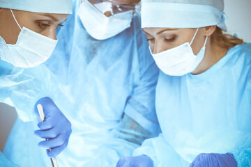 A group of surgeons is operating at the hospital. Health care concept