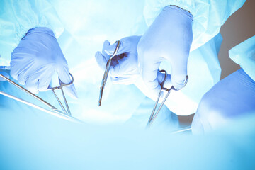 A group of surgeons is operating at the hospital, close-up of hands. Health care concept