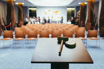 Hammer for the auction, on the background of the conference hall