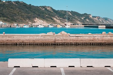 A reinforced concrete pier with concrete spalling in the port of Pesaro (Marche, Italy, Europe)