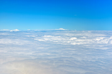 Naklejka premium Clouds against blue sky view through an airplane window for a background.