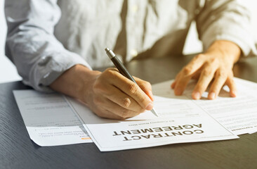 Business man signing document. Business man signing contract. Close up of business manager signing document on table.