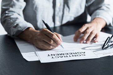 Business man signing document. Business man signing contract. Close up of business manager signing document on table.