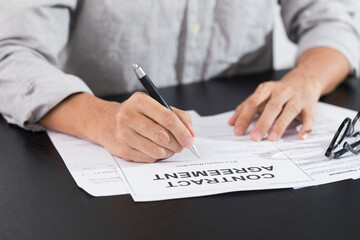 Business man signing document. Business man signing contract. Close up of business manager signing document on table.