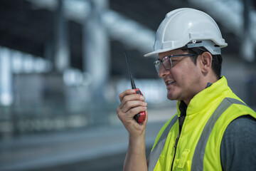 worker talking on the phone. worker using radio communication  on site construction.