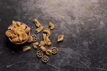 Raw pasta lines on gray background. Top view.