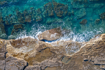 Sea waves breaking on rocky shore, aerial natural background