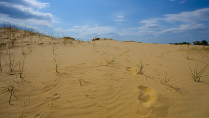 sandy desert dune under a cloudy sky, hot summer natural scene