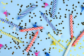 Birthday background with colored candles and shiny stars on a blue background. festive mockup.